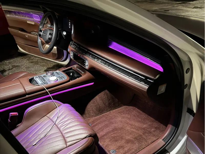 Bentley passenger side interior with purple ambient lighting - luxury vehicle detail