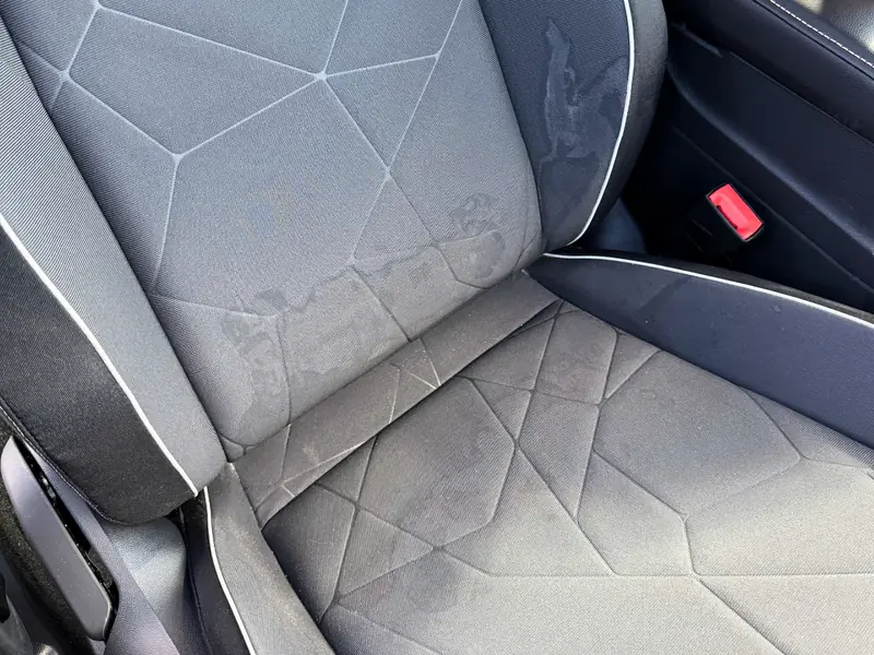 Cloth passenger seat before cleaning - visible stains and dirt