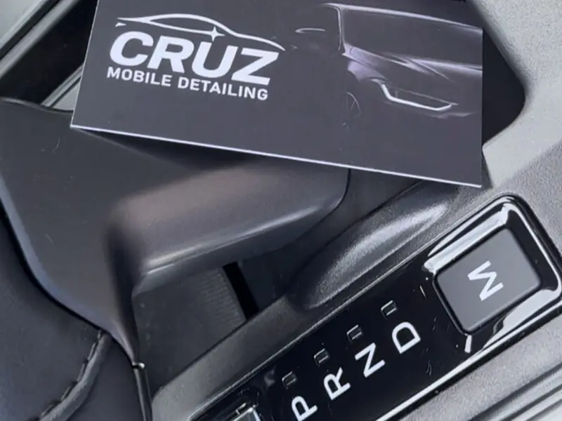 Cruz Mobile Detailing business card on detailed center console