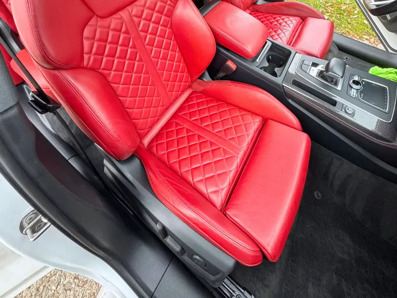 Red leather seats and detailed floor mats - passenger side view